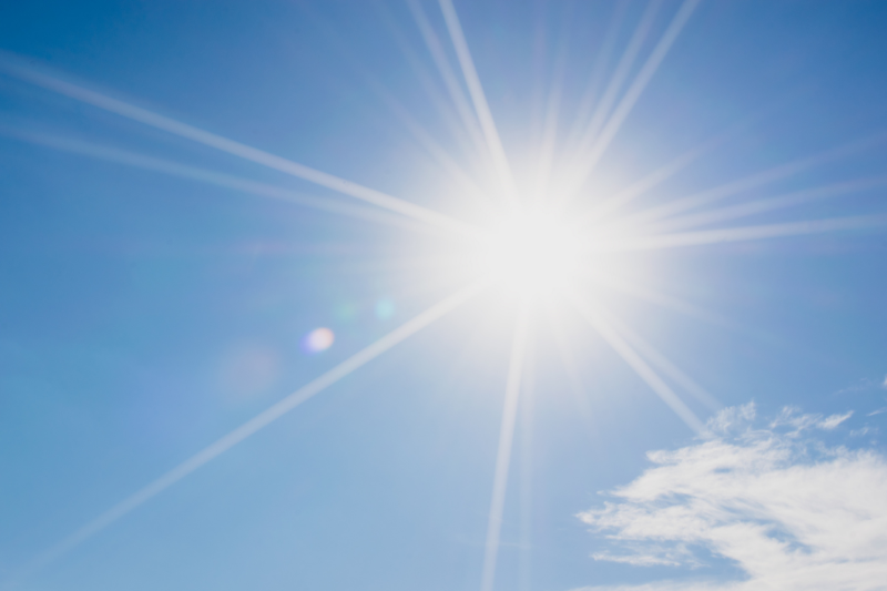 Blue sky with a bright sun shining.